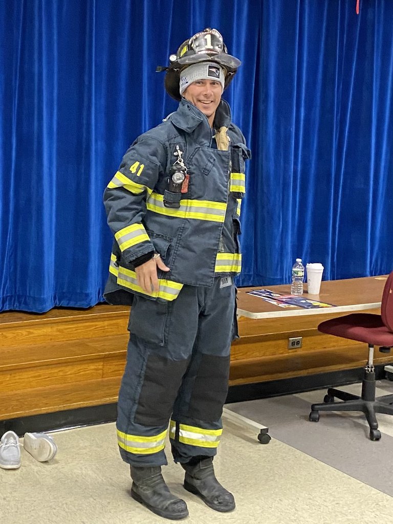 Teacher dressed in firefighter gear